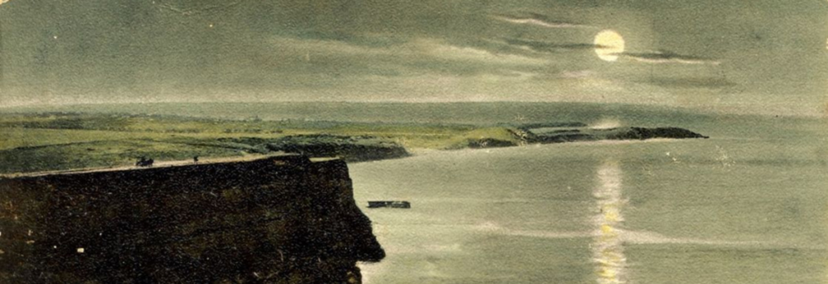 cliffs near ocean's edge with moon above