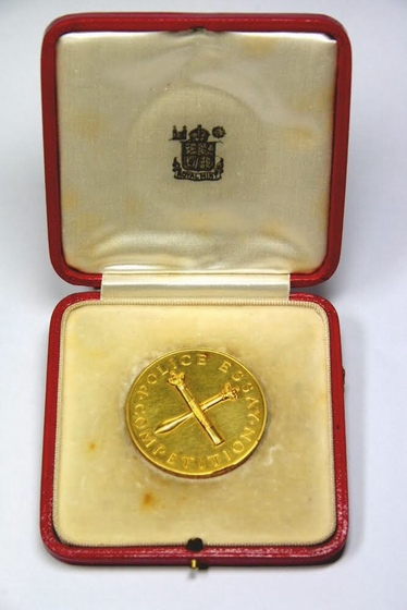 gold medallion in red box cream interior