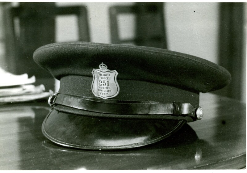 police uniform hat with badge on table