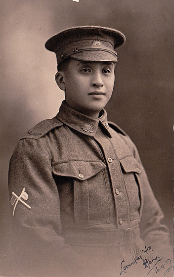 formal studio portrait of young soldier Ben Moy in full military uniform (enlistment portrait), period image, sepia tone.