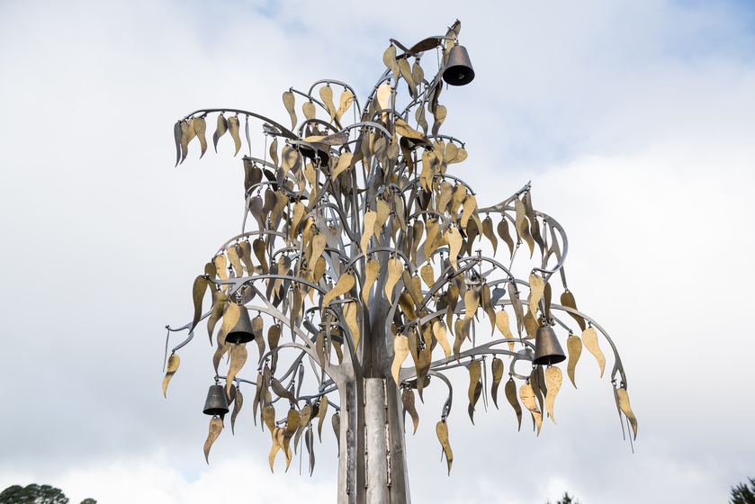 public art metal tree leaves against clouds