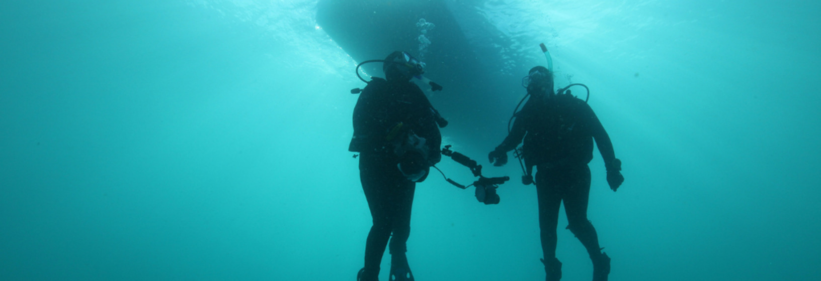 two divers swim underwater