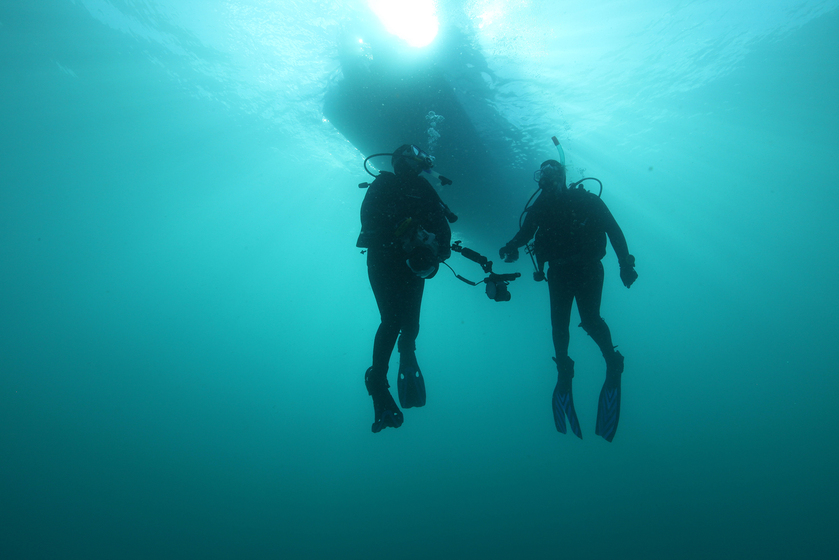 Two divers deep underwater