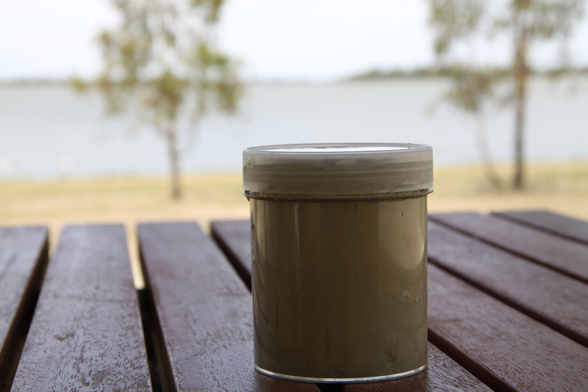 Container sitting on table with lake in background