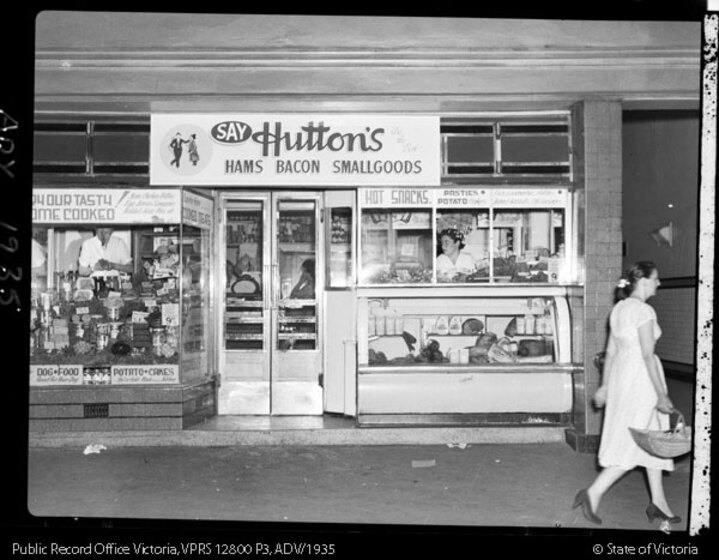a woman walks past Hutton's Deli on the station concourse