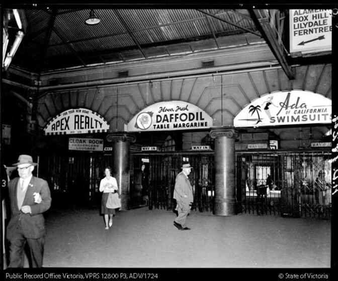 People walking through entrance of station