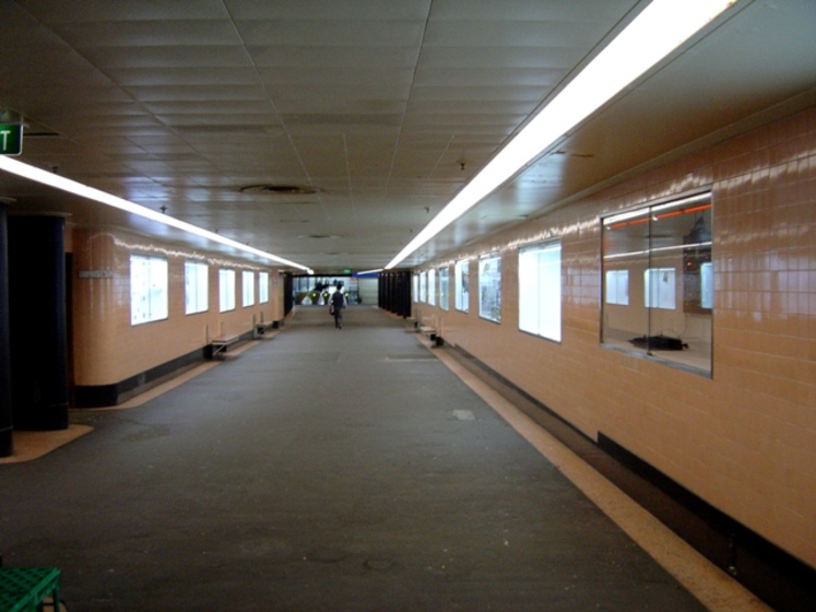 looking down the corridor of the Degraves Street underpass, with one passenger in the distance