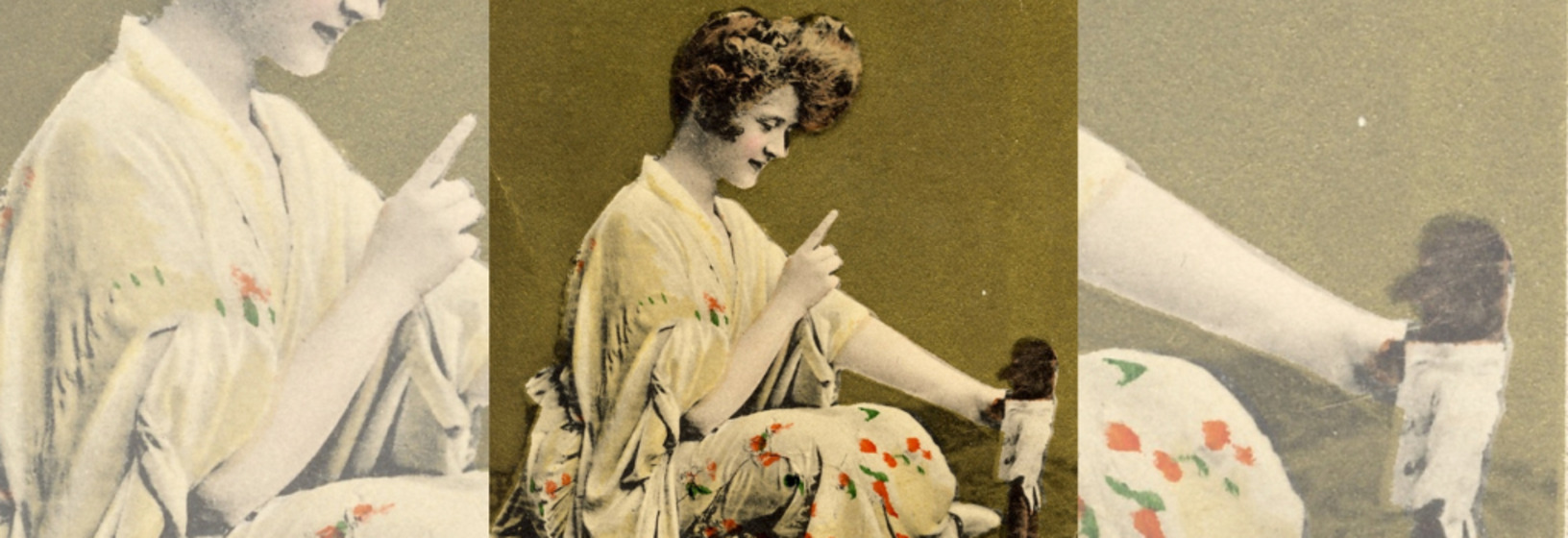 a woman sits cross-legged wearing a kimono and pointing at doll
