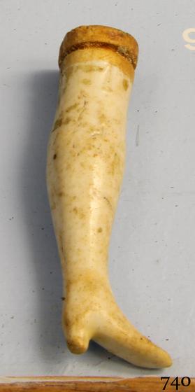 a small doll's leg in ivory colour