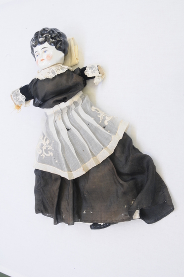 porcelain doll in black and white lace dress
