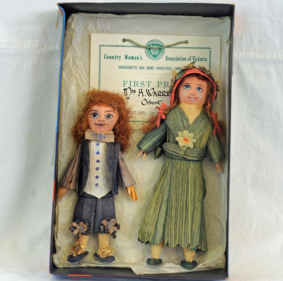 Two hand-made dolls, one boy and one girl, in a box along with First Prize certificate from Country fair