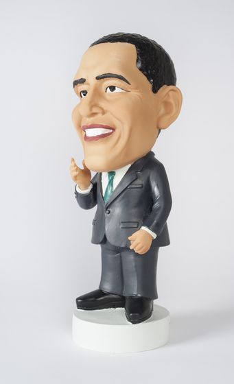 a figurine depicting Barack Obama in suit