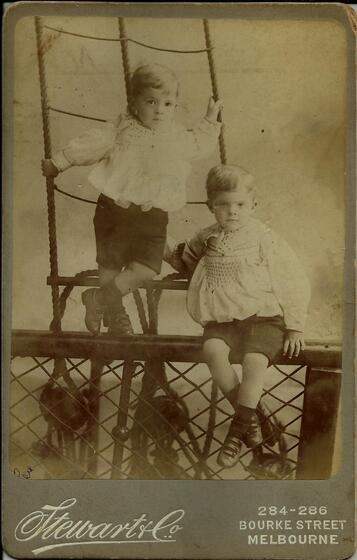 Sepia image of two children on rigging