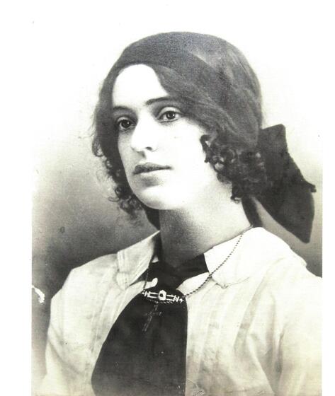 Monochrome image of woman wearing a shirt and tie with headband