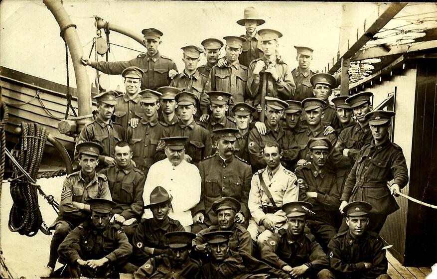 a group of men in assorted military uniform onboard a ship