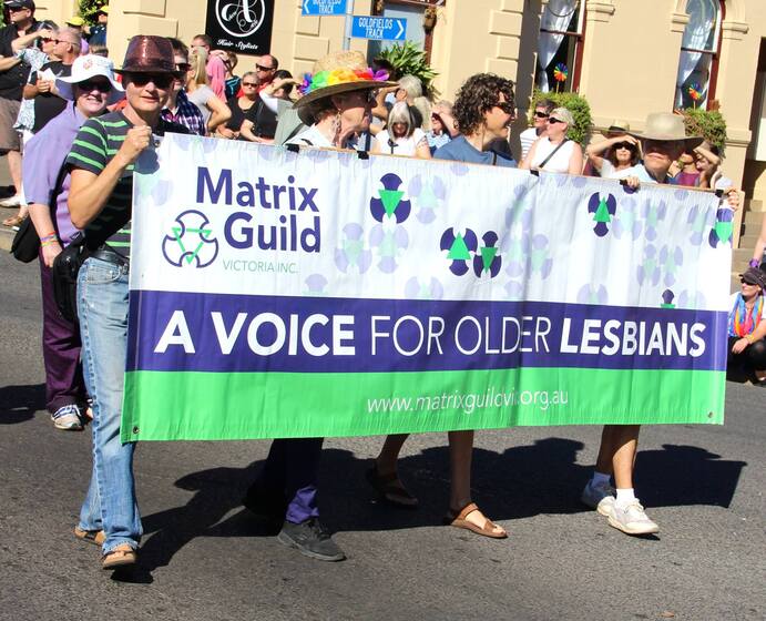 group of women holding 'a voice for older lesbians' banner and marching