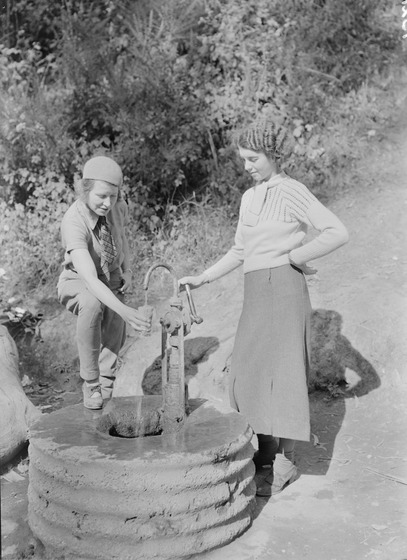 Two women pump mineral water pump at Hepburn Springs some time in the mid 1940s or early 1950s.