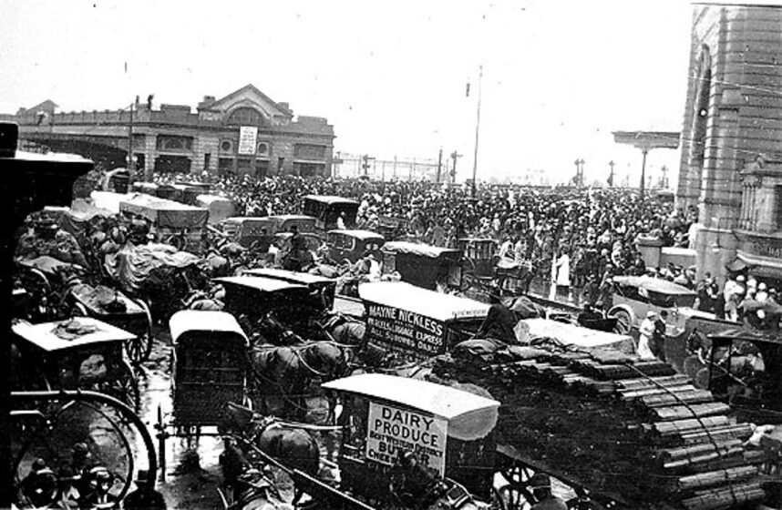 horse-drawn cabs, carts and drays clog an intersection