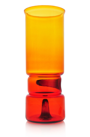 a glass vase which is yellow at the top and gradually changes to red at the bottom. The gradation is the result of the glass changing colour each time it is heated.
