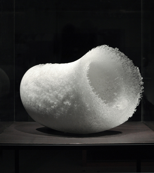 a white glass sculptural form, the surface of which appears like snow and ice