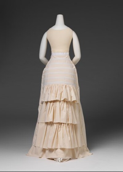 a white undergarment on mannequin shown from back