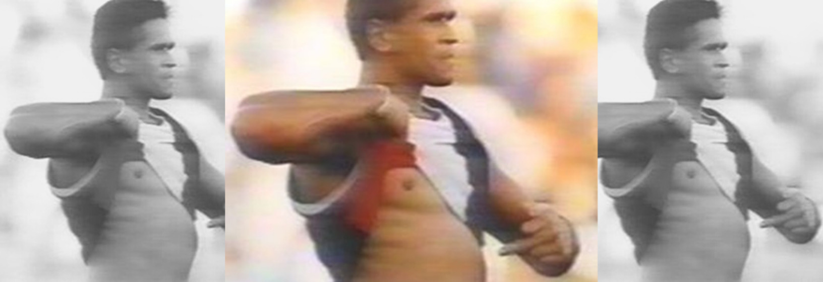 three repeated shots of an aboriginal football player raising his shirt and pointing to his skin