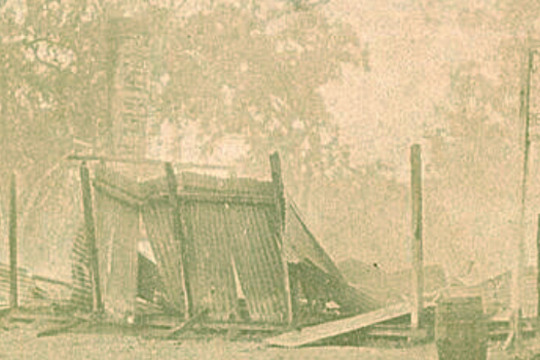 early image, burnt remains of a wooden building