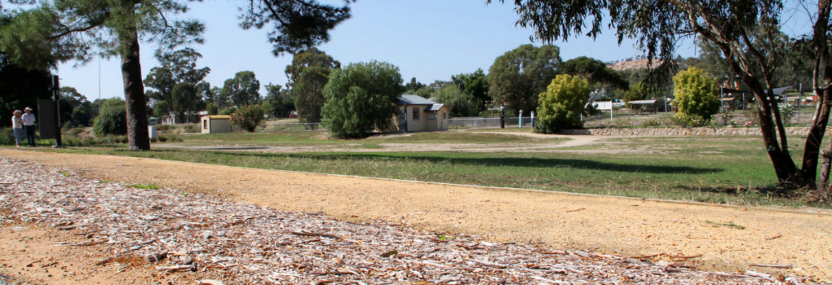open park with house in background