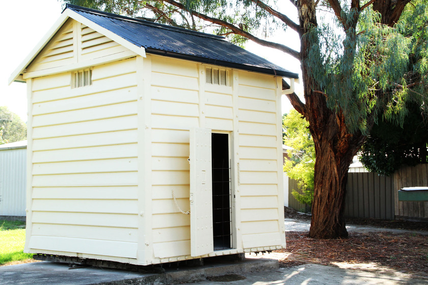 The Lock up exterior, a small cream coloured weatherboard timber structure.