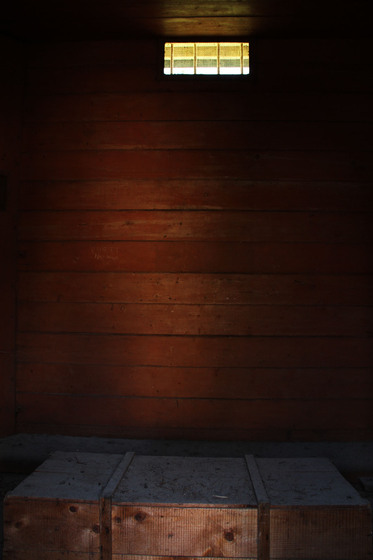 Lock up interior, showing a small timber room, ventilation shaft and wooden crate