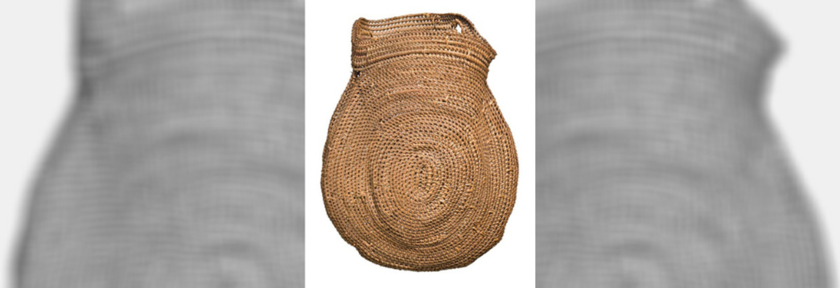 large woven basket in natural fibre with traditional circular motif