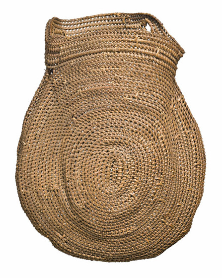 large woven basket in natural fibre with traditional circular motif