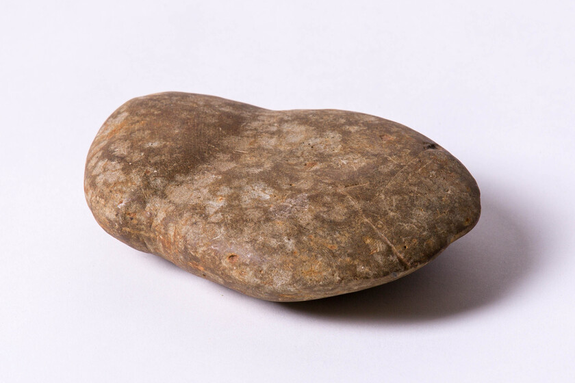 flattened, pale rock with shaped edged