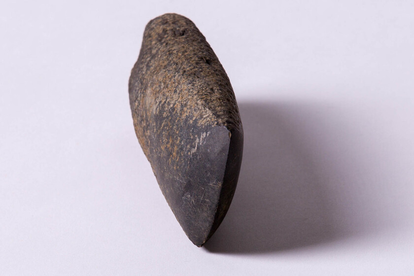 small dark stone shaped to a sharp edge