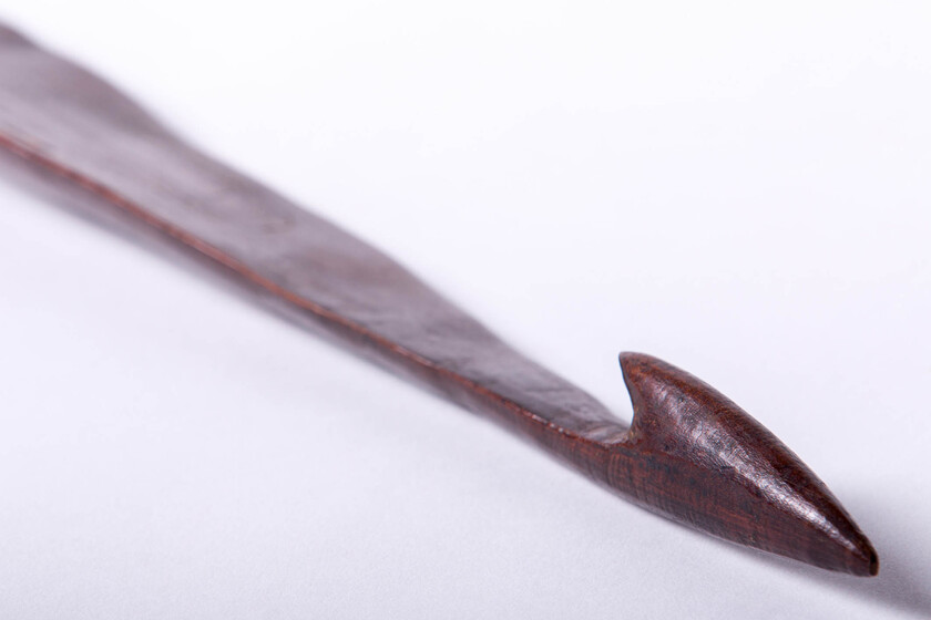 long narrow timber ending with a curved head