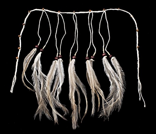 long beaded string featuring 10 sections holding a brown bead and emu feathers