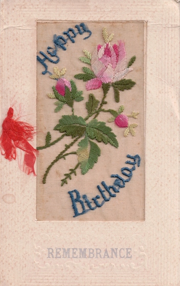 card with embroidered flower and text
