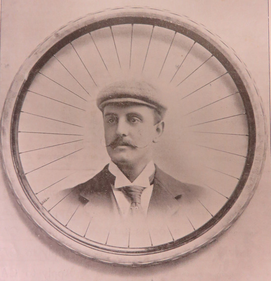Man's face printed inside of a bicycle wheel