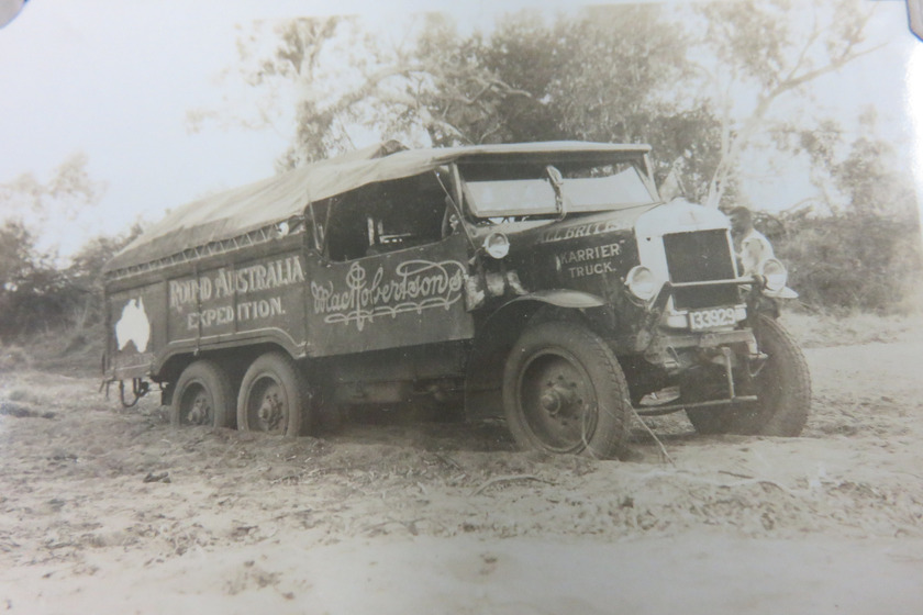 Large truck driving through mud