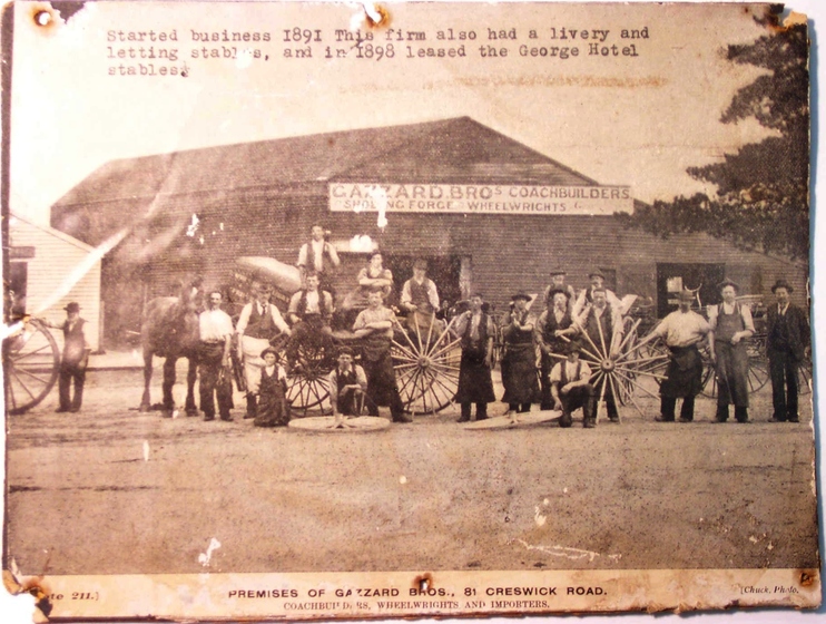 Photograph of men and women in front of barn