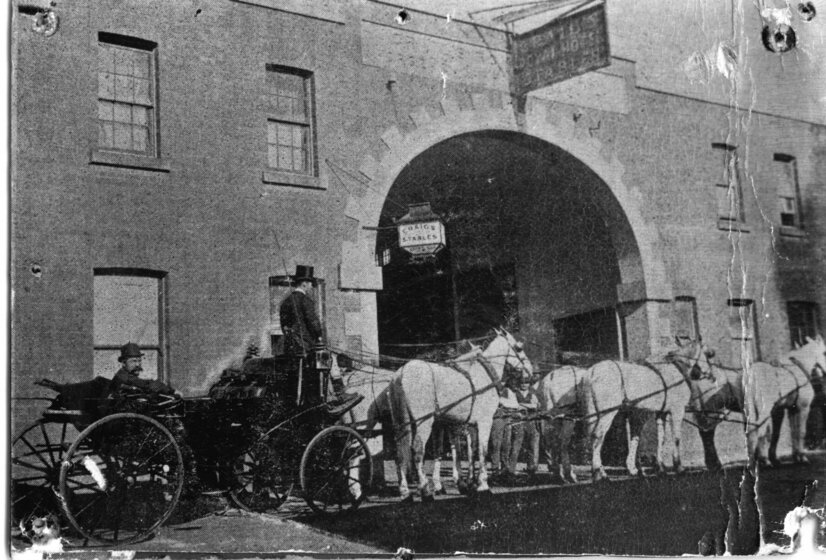 Carriage with two men drawn by six white horses