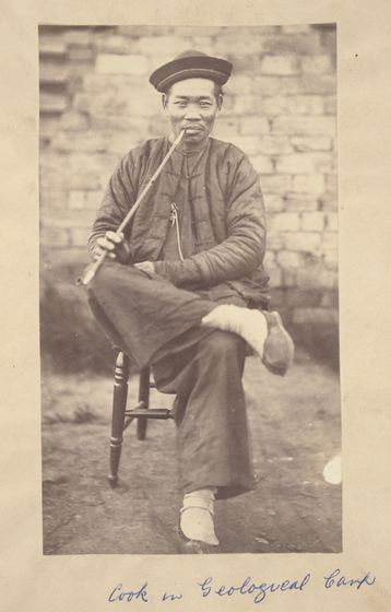 Man sitting on chair with pipe in mouth