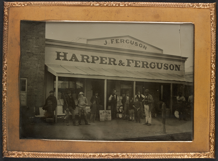 Store front with several people on the porch