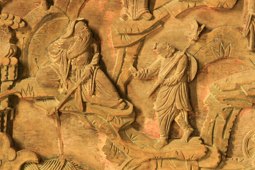 Carved panel with people in a scene