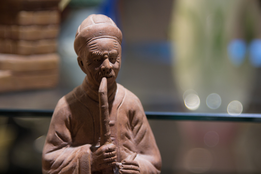 Figurine of a Chinese man smoking a pipe