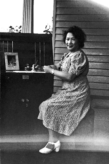 A woman sitting at a writing desk