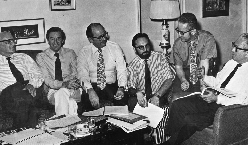 Men working together around a desk