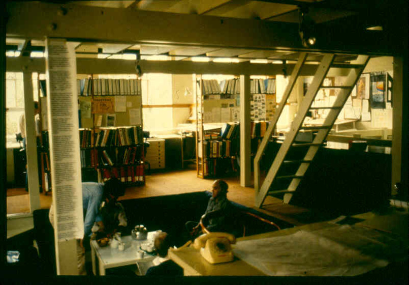 Man sitting in his office surrounded by books