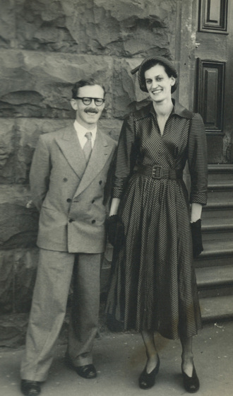 Couple standing in front of a stone wall