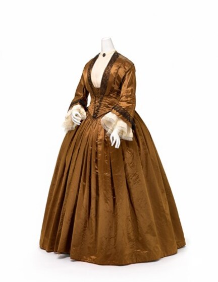 Golden dress on a mannequin seen from side